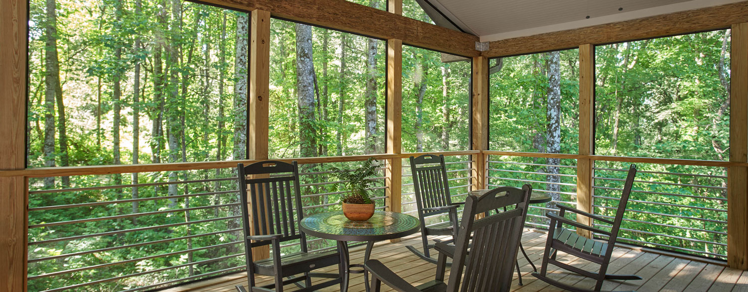 Screen Porch with views of the woods at Highlander Lodge